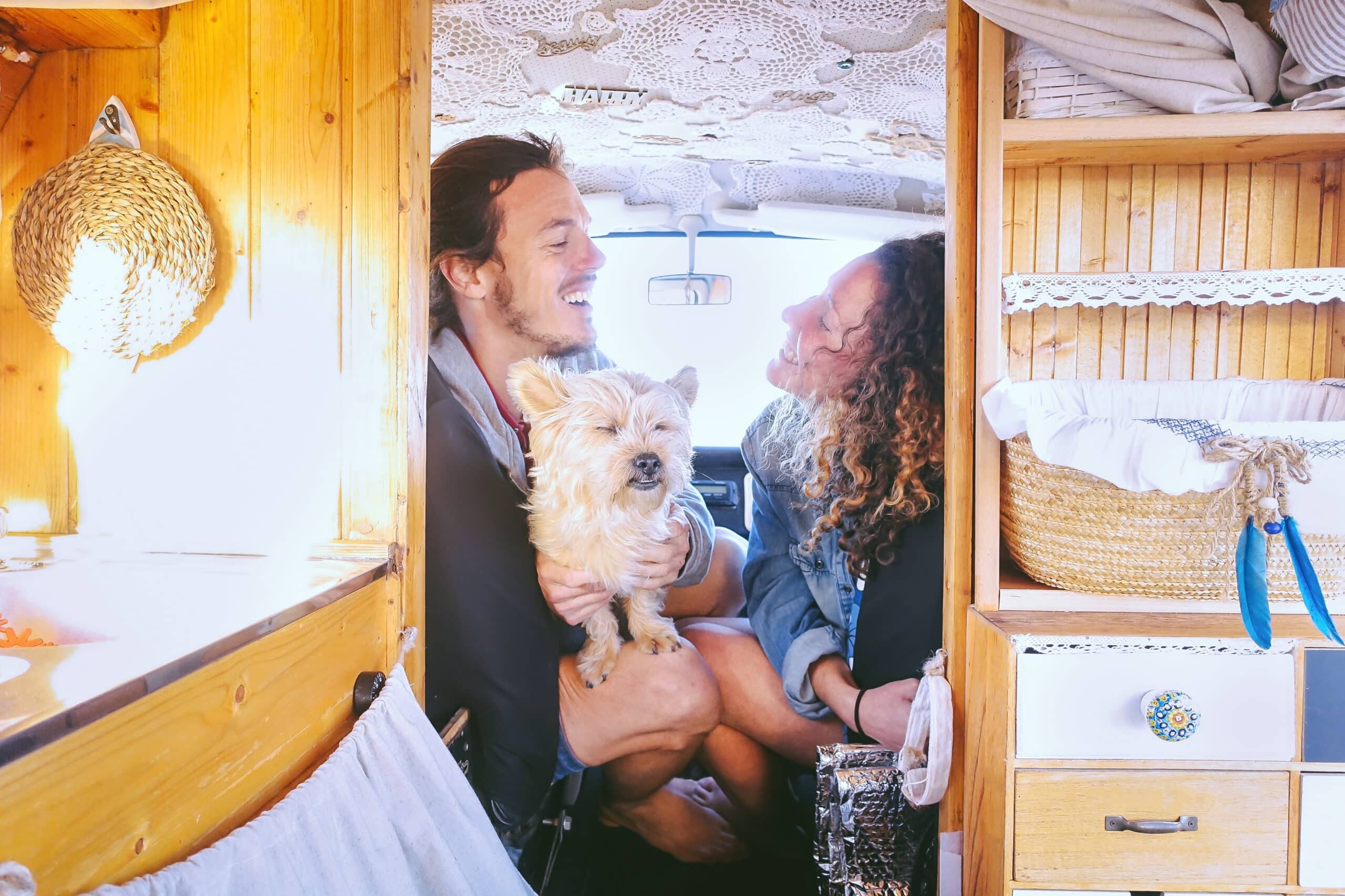 Couple with their dog in their mobile home